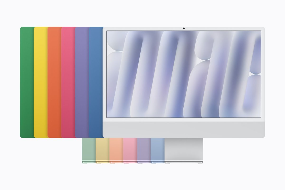 Front of the silver iMac with M6 with the other six colours fanned out behind it