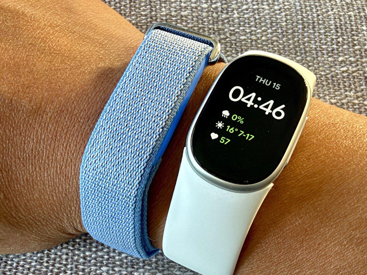 Fitbit Edge watch face showing time, weather and heart rate next to a Fitbit Air on the wrist