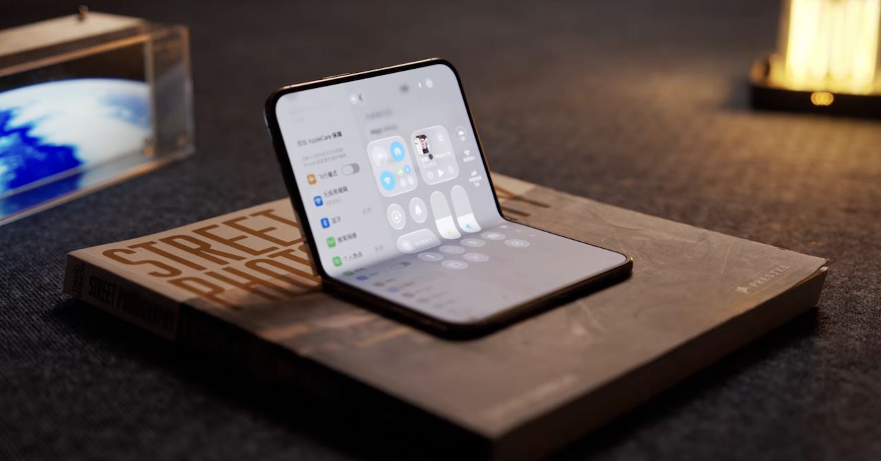 iPhone Duo Bend Test | iPhone in Canada Foldable smartphone opened on a worn hardcover book titled Street Fighter, resting on a dark desk with warm lighting.