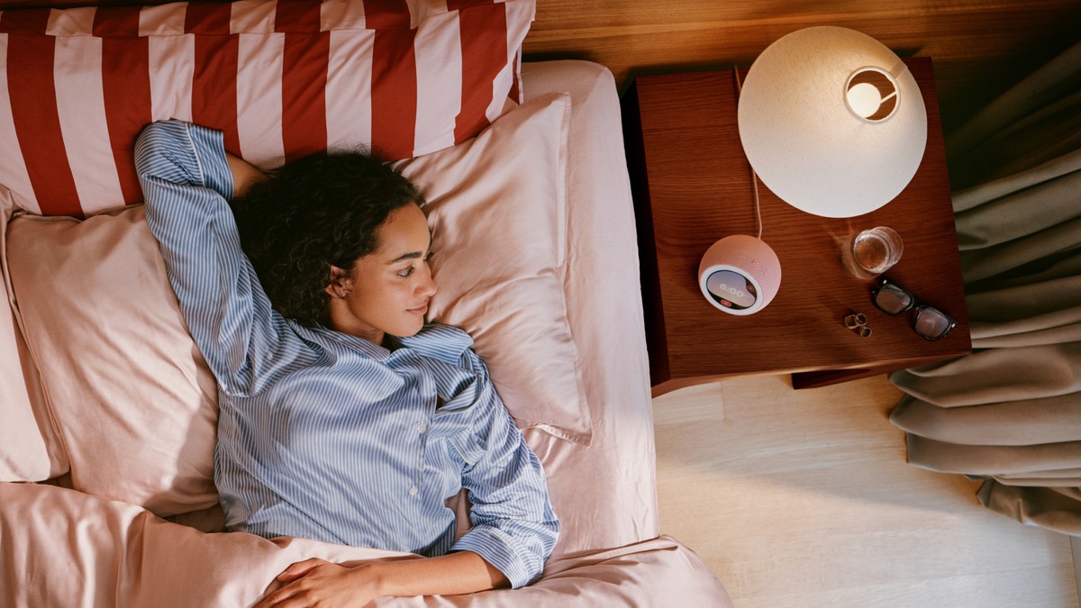 Amazon Echo Time smart alarm clock on a nightstand with a circular display